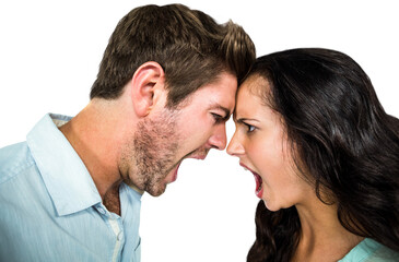 Frustrated couple shouting while standing face to face