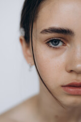 Naklejka premium natural girlish beauty without makeup, minimalism and sophistication. Stylish portrait of a young girl