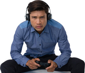 Portrait of young businessman wearing headphones while playing video game