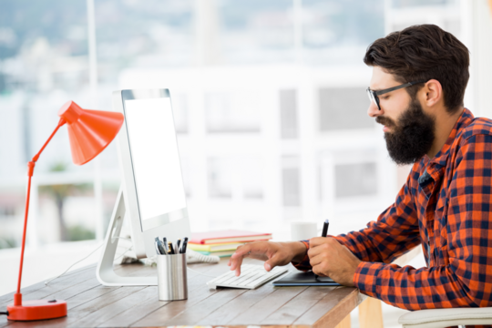 Hipster drawing on graphic tablet