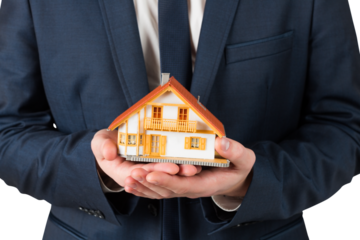 Businessman holding miniature house model