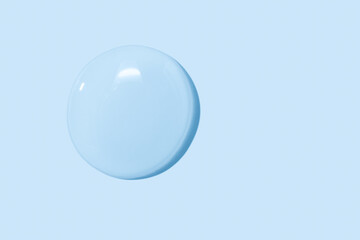 large drops of transparent Gel liquid, water on a blue background, top view, close-up