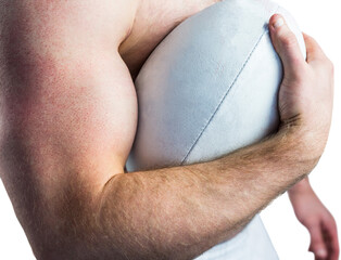 Shirtless rugby player holding ball