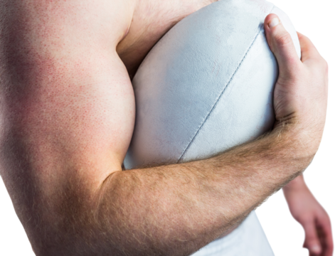 Shirtless rugby player holding ball