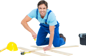 Happy repairman fixing screw on plank