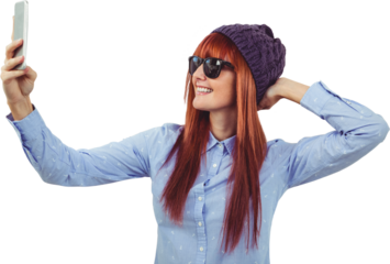 Smiling hipster woman taking selfie