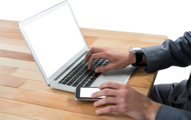 Cropped image of businessman using laptop