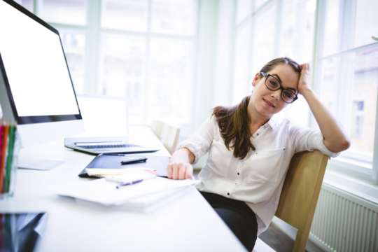 Portrait of tired woman sitting on chair