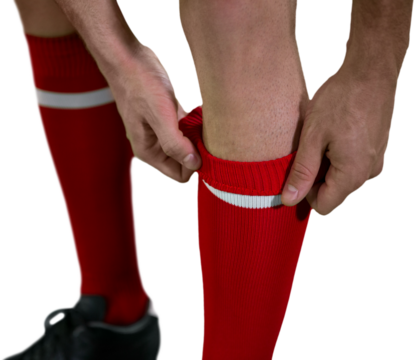 Low section of football player pulling his socks up - Powered by Adobe