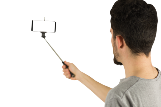 Casual man using a selfie stick