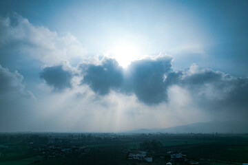 sun behind clouds