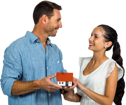 Face to face couple holding house model