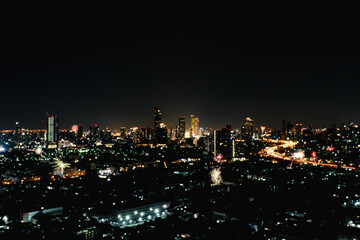 Blur background buildings metropolitan condo high street road blurry bokeh light nightlife dark sky night. Defocused blurred thailand Bangkok landscape building with street way. Business background