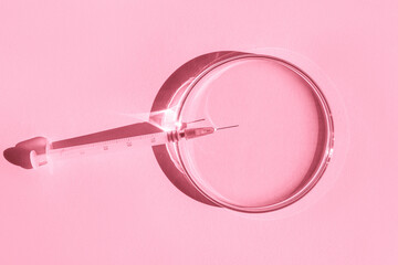Petri dishes. small syringe. On a pink background.