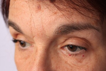 Fototapeta premium Skin care. Senior woman on white background, closeup