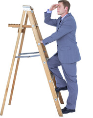 Businessman looking away while climbing on ladder