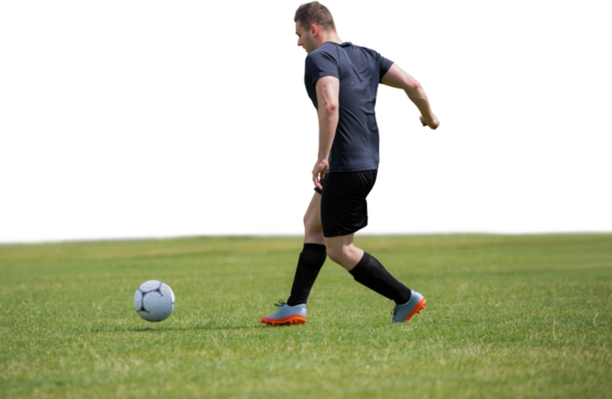 Male soccer player playing football