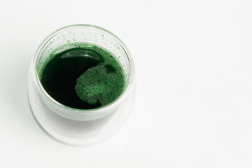 Spirulina diluted in water. Green drink in a glass..  Spirulina, superfood, bioadditive. Green. Eco