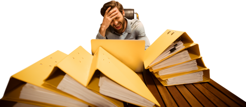 Frustrated businessman with files sitting at table