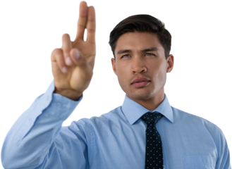 Confident young businessman touching invisible interface