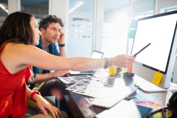 Coworkers discussing project on computer