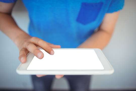 Schoolboy using digital tablet in corridor - Powered by Adobe