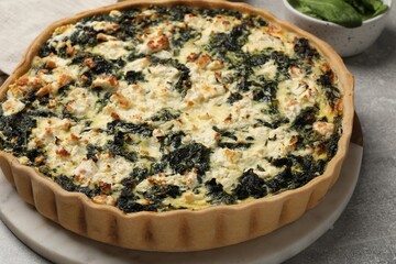 Delicious homemade spinach quiche on table, closeup