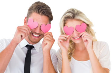 Attractive young couple holding pink hearts over eyes