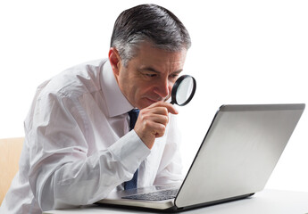 Mature businessman examining with magnifying glass