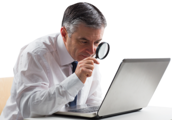 Mature businessman examining with magnifying glass