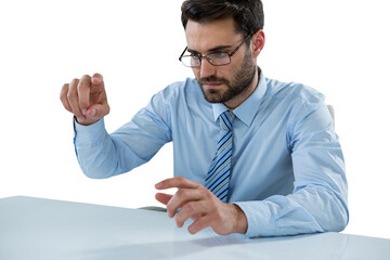 Businessman pretending to touch invisible object at desk