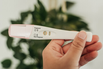 Close up woman holding pregnancy test