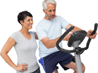 Happy woman looking at mature man on stationary bike