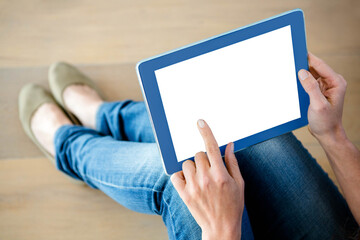 Low section of woman using digital tablet