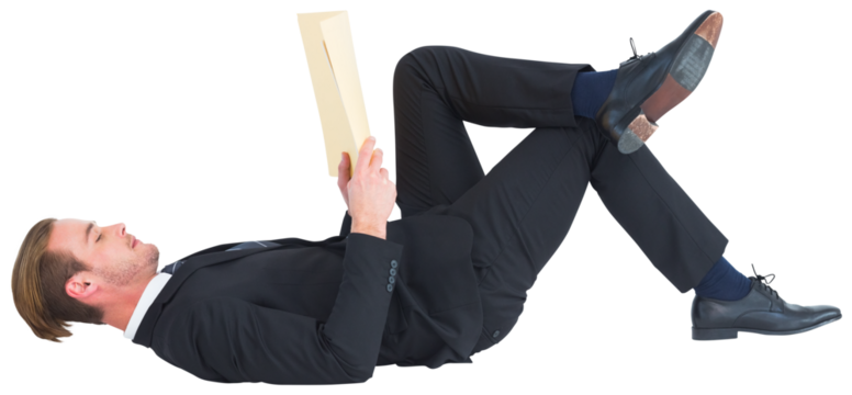 Relaxed businessman lying and reading book