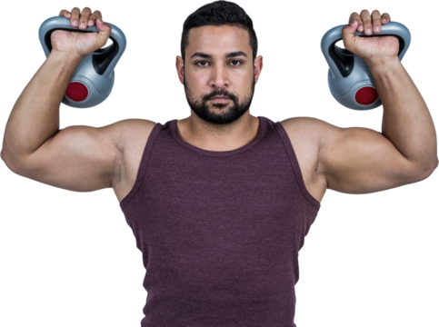 Muscular serious man lifting kettlebells