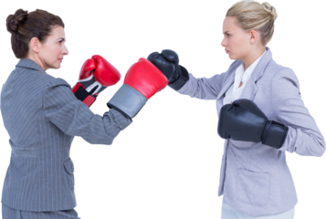 Aggressive businesswomen boxing over white background