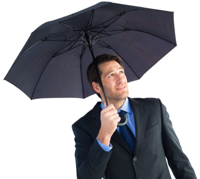 Businessman sheltering with black umbrella
