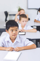 Schoolboy sitting in classroom