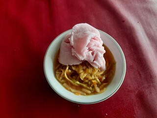 a rujak or spicy fruit salad dish topped with strawberry ice cream