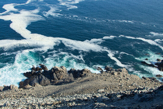sea waves crash against the rocks