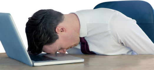 Exhausted businessman sleeping head on laptop