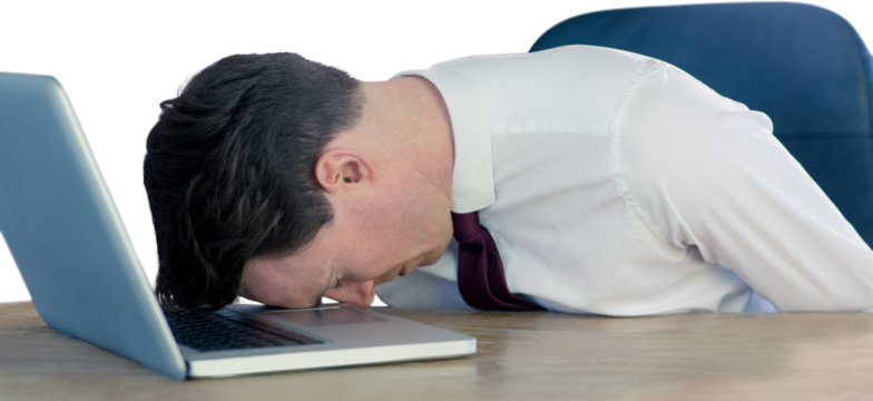 Exhausted businessman sleeping head on laptop