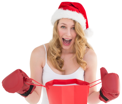 Shocked blonde opening a shopping bag with boxing gloves 