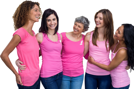 Smiling women in pink outfits talking while posing for breast cancer awareness