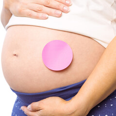 Pregnant woman with sticker on bump