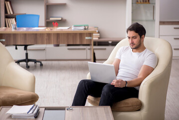 Young male employee working from home during pandemic