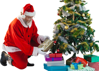 Santa Claus arranging presents near Christmas tree
