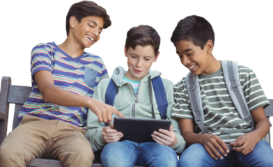 Boy with friends using digital tablet on bench