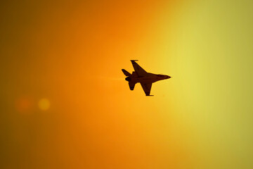 jet fighter airplane in the sunset